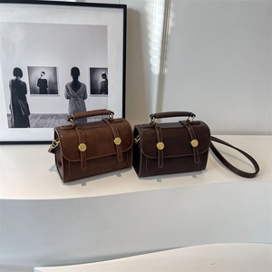 Vintage mini square bags in brown and dark coffee with golden buckles on a pedestal