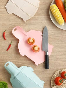 Three-piece set of portable pig-shaped folding cutting boards in pink, blue, and beige
