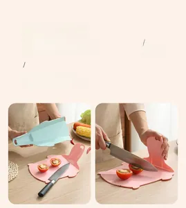 Close-up of flexible silicone cutting board folding to pour chopped vegetables easily