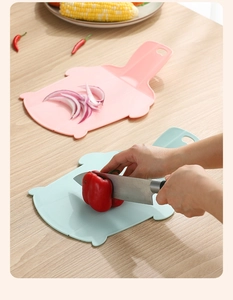 Macro view of portable pink and mint flexible cutting boards with non-slip texture