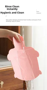 Macro shot of pink turtle-shaped silicone cutting board being rinsed under running water