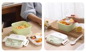Detail of double-layer light green bento box with utensil compartment and dividers