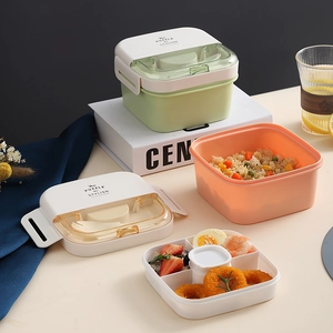 Modern double-layer stackable bento box with divided trays and utensils in green and pink