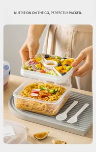 Detail of multi-layer 1100ml bento box showing the removable 3-compartment tray and sauce cup