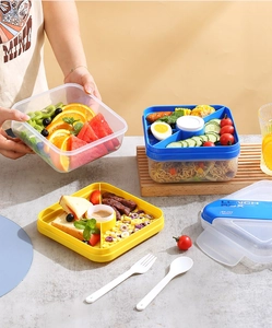 Detail of multi-compartment portable lunch box with divided trays for meal prep storage