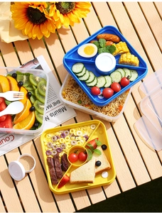 Close-up of portable divided lunch box with yellow and blue trays for food separation