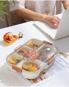 Detail of a 5-compartment lunch box with a cute bear lid and secure brown locking clips