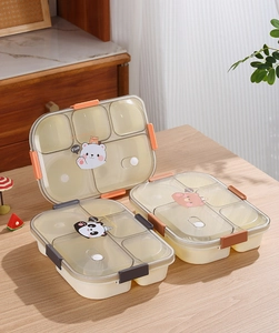 Detail of five-compartment lunch box with transparent lid featuring cute cartoon designs