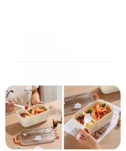 Dual-compartment bento box with cute bear lid and spoon on wooden table setting