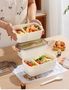Detail view of multi-compartment lunch box with pasta, fruit and secure side buckles