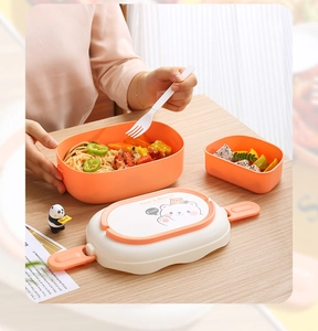 Detail of partitioned plastic lunch box with cute bear print and secure side buckles