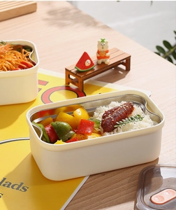 Divided 304 stainless steel lunch box with food compartments and orange locking lid detail