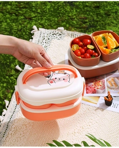Close-up of double-layer bear lunch box with orange lid and portable handle for picnic