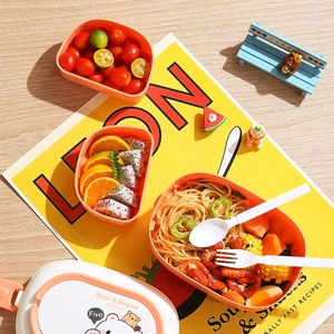 Double-layer orange bear lunch box with handle for students and adults shown with food