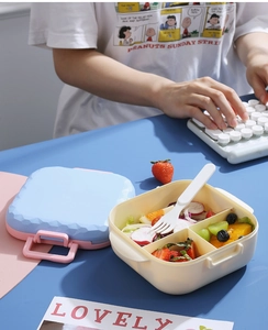 Close-up of three-compartment bento box with diamond texture lid and reusable fork