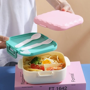 Three-layer bento lunch box with macaron pink lid, green utensil layer and white compartments