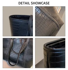 Close-up of black crocodile embossed faux leather tote bag with detailed stitching