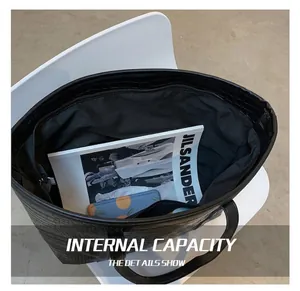 Interior view of black crocodile embossed tote bag showing spacious capacity and pocket