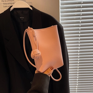 Pink lychee grain leather mini shoulder bag with decorative knotted rope handle design