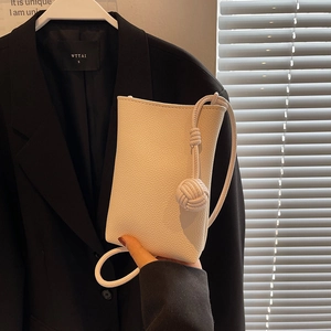 Mini white crossbody shoulder bag with lychee texture PU leather and woven knot detail
