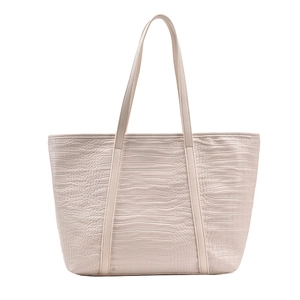 Close-up of elegant crocodile embossed texture on large beige tote bag with slim straps