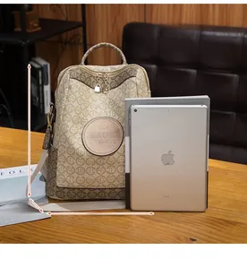 Detailed size view of beige vintage backpack with brown logo print and 32x29x13cm dimensions