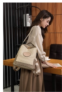 Detail of vintage patterned backpack with leather trim and gold zippers in a cozy setting