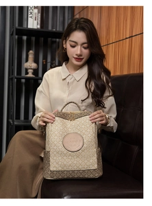 Detail of light brown backpack with geometric pattern, leather logo and gold zippers