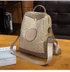 Detail of vintage logo pattern backpack with JIAOLI circular metal logo and zip closure