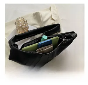 Black quilted croissant bag capacity showing storage for phone wallet and makeup