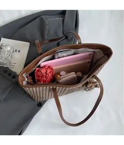 Spacious interior of houndstooth tote bag holding tablet, phone, and daily essentials