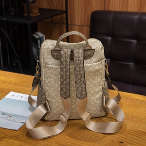 Vintage monogram backpack in beige canvas with wide nylon straps on a wooden table