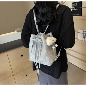 Silver bucket backpack with metallic pleated texture and plush cloud charm detail
