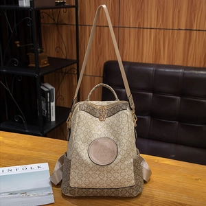 Retro monogram canvas backpack with leather handle shown on a wooden table setup