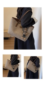 Detail view of large houndstooth tote bag with leather trim and rabbit charm