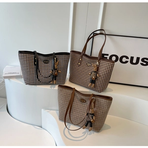 Detailed view of houndstooth tote bags in black and brown with cute rabbit charms