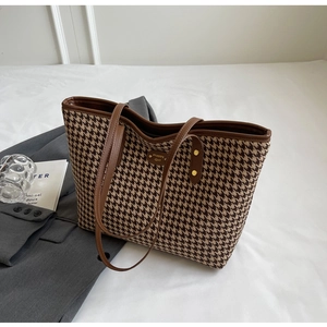 Top view of houndstooth tote bag with brown leather handles and Happy Girl label