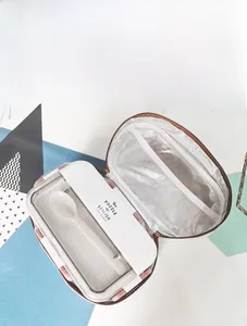 Detail view of insulated lunch bag with foil lining, white bento box and spoon set