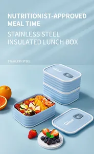Blue double-layer stainless steel lunch box with air vent and fresh salad inside