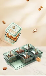 Detail of luxury green glass fruit box set with gold handle and 5 individual lidded containers