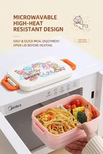 Close-up of pink microwave-safe bento box with dual handles and unicorn pattern