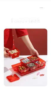 Detail of red transparent divided snack plate with gold festive character and handle tray