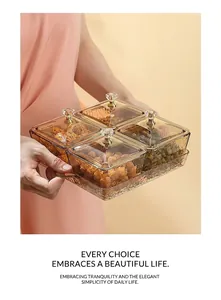 Macro view of four-compartment amber snack tray with gold handles and a portable tray