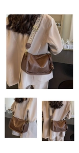 Dettaglio borsa vintage in pelle marrone con ampia tracolla geometrica nera e bianca