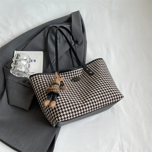 Houndstooth pattern tote bag with black leather straps and a cute bunny charm