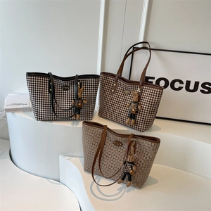 Three elegant houndstooth tote bags with leather straps and cute rabbit charms