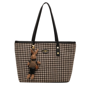 Classic houndstooth tote bag with black leather straps and a cute rabbit charm