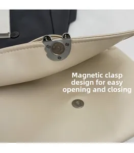 Detail showing the magnetic clasp design of the beige leather bag for easy opening