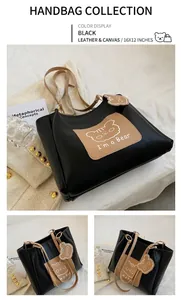 Detail view of black tote bag featuring a cute cartoon bear print and brown shoulder straps