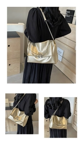 Detail view of gold metallic shoulder bag with chain strap and circular ring buckle
